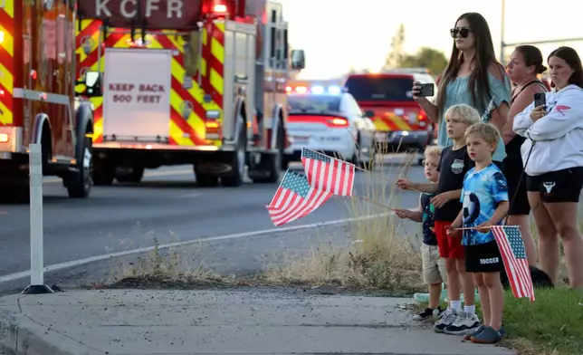 A procession from Kootenai Health heads to the medical examiner's office in Spokane, Wash., after firefighters were killed Sunday, June 29, 2025, when they were ambushed by sniper fire while responding to a blaze near Coeur d’Alene, Idaho. (Bill Buley/Coeur D'Alene Press via AP)