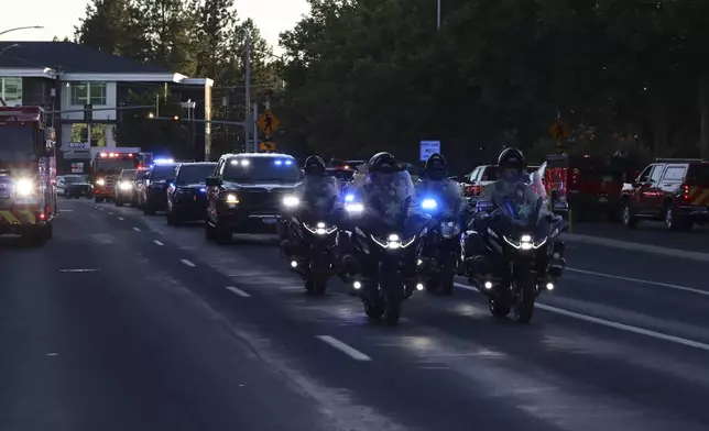 A procession from Kootenai Health heads to the medical examiner's office in Spokane, Wash., after firefighters were killed Sunday, June 29, 2025, when they were ambushed by sniper fire while responding to a blaze near Coeur d’Alene, Idaho. (Bill Buley/Coeur D'Alene Press via AP)