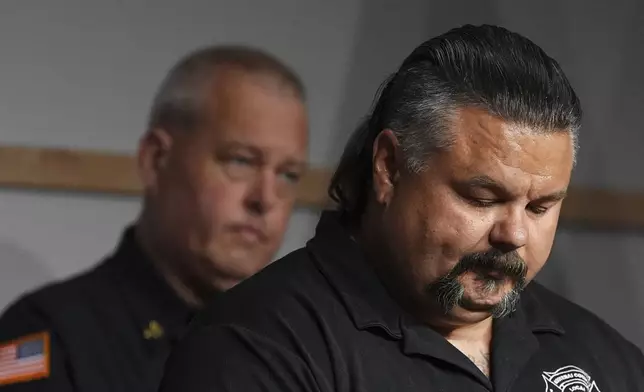 Kootenai County Fire &amp; Rescue Local 2856 President Justin Zabel pauses while becoming emotional during a press conference announcing the names of the firefighters killed and wounded the day before by a shooter while responding to a wildfire at Canfield Mountain, Monday, June 30, 2025, in Post Falls, Idaho. (AP Photo/Lindsey Wasson)