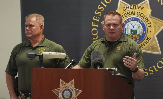 Kootenai County Captain Jeremy Hyle, right, answers questions as Kootenai County Sheriff Bob Norris, left, looks on during a press conference the day after a shooter ambushed and killed multiple firefighters responding to a wildfire at Canfield Mountain Monday, June 30, 2025, in Hayden, Idaho. (AP Photo/Lindsey Wasson)