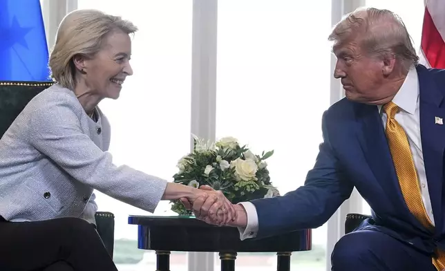 President Donald Trump and European Commission President Ursula von der Leyen shake hands after reaching a trade deal at the Trump Turnberry golf course in Turnberry, Scotland Sunday, July 27, 2025. (AP Photo/Jacquelyn Martin)