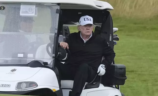 President Donald Trump steers a golf cart at the Trump Turnberry golf course in Turnberry, Scotland, Saturday, July 26, 2025.(AP Photo/Alastair Grant)
