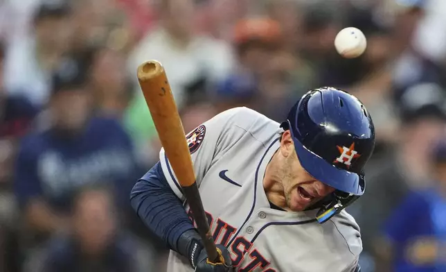 Houston Astros' Zack Short is hit by a pitch from Seattle Mariners relief pitcher Carlos Vargas during the sixth inning of a baseball game Saturday, July 19, 2025, in Seattle. (AP Photo/Lindsey Wasson)