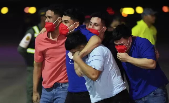 Migrants deported months ago by the United States to El Salvador under the Trump administration's immigration crackdown arrive at Simon Bolívar International Airport in Maiquetia, Venezuela, Friday, July 18, 2025. (AP Photo/Ariana Cubillos)