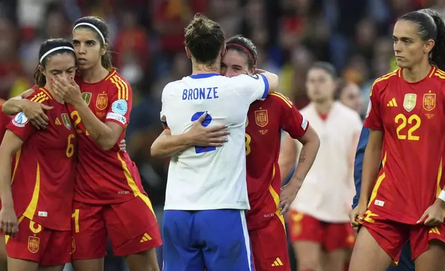 England's Lucy Bronze, hugs Spain's Mariona Caldentey at the end of the Women's Euro 2025 final soccer match between England and Spain at St. Jakob-Park in Basel, Switzerland, Sunday, July 27, 2025. (AP Photo/Alessandra Tarantino)