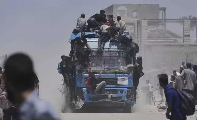 Palestinians hold onto an aid truck returning to Gaza City from the northern Gaza Strip on Tuesday, July 22, 2025. (AP Photo/Jehad Alshrafi)