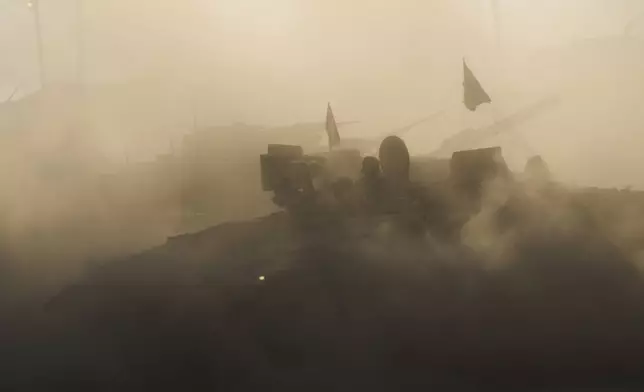 An Israeli military APC maneuvers at a gathering point near the Gaza Strip, in southern Israel, July 21, 2025. (AP Photo/Ariel Schalit)