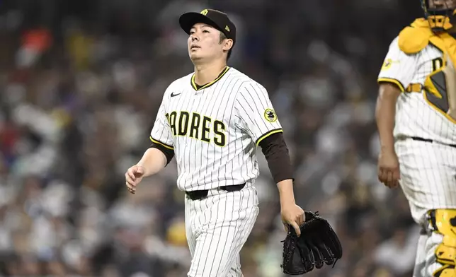 San Diego Padres relief pitcher Yuki Matsui, left, leaves during the seventh inning of a baseball game against the Texas Rangers, Saturday, July 5, 2025. (AP Photo/Denis Poroy)