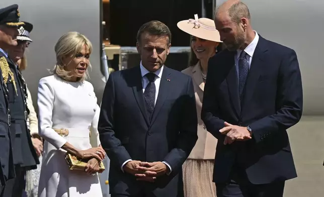 France's President Emmanuel Macron and his wife Brigitte Macron, left, are greeted by Britain's Prince William, right, and Kate, Princess of Wales at RAF Northolt, west of London, Tuesday July 8, 2025, on the first day of a three-day state visit to Britain. (Justin Tallis/Pool via AP)