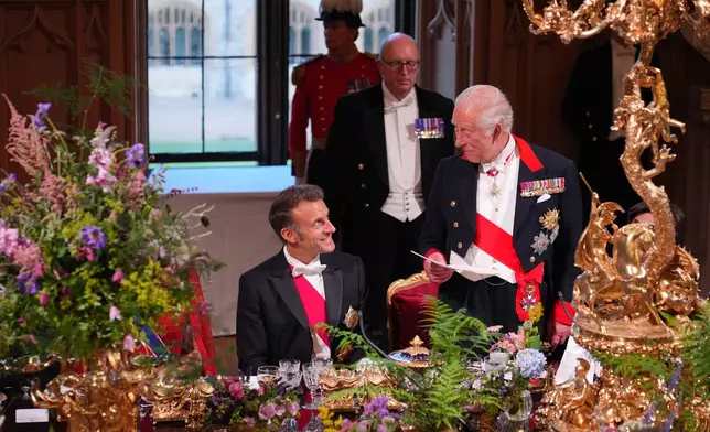 Britain's King Charles III speaks at the State Banquet for President of France Emmanuel Macron, left, and his wife Brigitte Macron, at Windsor Castle, in Windsor, England, Tuesday, July 8, 2025. (Yui Mok/Pool Photo via AP)