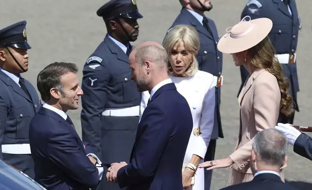 France's President Emmanuel Macron, second left, and his wife Brigitte Macron, second right, are greeted by Britain's Prince William, center, and Kate, Princess of Wales, right, at RAF Northolt, west of London, Tuesday July 8, 2025, on the first day of a three-day state visit to Britain. (Geoff Pugh/Pool via AP)