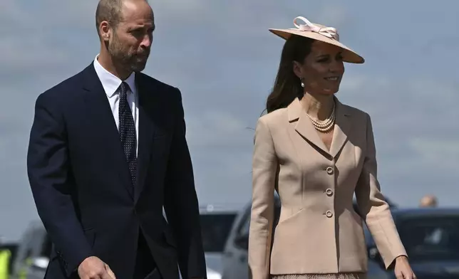 Britain's Prince William, and Britain's Kate, Princess of Wales arrive to greet France's President Emmanuel Macron and his wife Brigitte Macron, at RAF Northolt, west of London, Tuesday July 8, 2025, on the first day of a three-day state visit to Britain. (Justin Tallis/Pool via AP)
