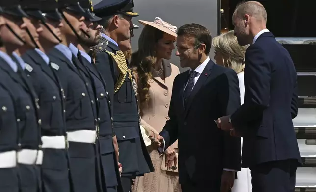 France's President Emmanuel Macron and his wife Brigitte Macron, second right, are greeted by Britain's Prince William, right, and Kate, Princess of Wales at RAF Northolt, west of London, Tuesday July 8, 2025, on the first day of a three-day state visit to Britain. (Justin Tallis/Pool via AP)