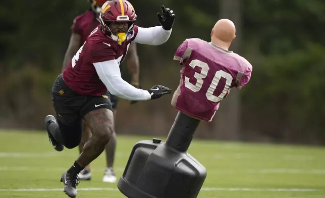 Washington Commanders linebacker Von Miller (24) runs a drill during practice at the team's NFL football training camp, Wednesday, July 23, 2025, in Ashburn, Va. (AP Photo/Mark Schiefelbein)