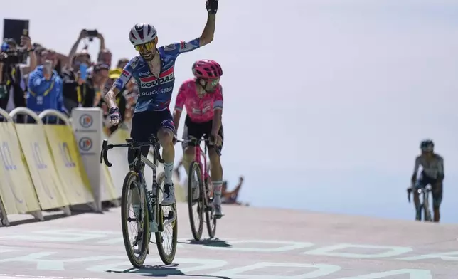 France's Valentin Paret Peintre crosses the finish line ahead of Ireland's Ben Healy to win the sixteenth stage of the Tour de France cycling race over 171.5 kilometers (106.6 miles) with start in Montpellier and finish on the Mont Ventoux, France, Tuesday, July 22, 2025. (AP Photo/Mosa'ab Elshamy)