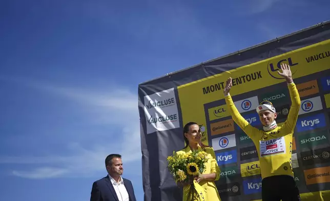 Slovenia's Tadej Pogacar, wearing the overall leader's yellow jersey, celebrates on the podium after sixteenth stage of the Tour de France cycling race over 171.5 kilometers (106.6 miles) with start in Montpellier and finish on the Mont Ventoux, France, Tuesday, July 22, 2025. (AP Photo/Thibault Camus)