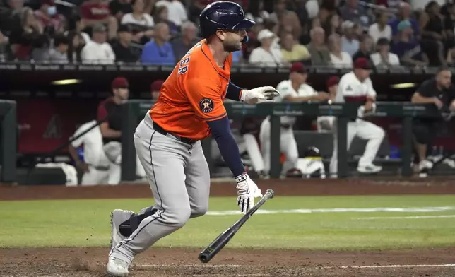 Houston Astros' Christian Walker hits an RBI single against the Arizona Diamondbacks in the ninth inning during a baseball game, Wednesday, July 23, 2025, in Phoenix. (AP Photo/Rick Scuteri)