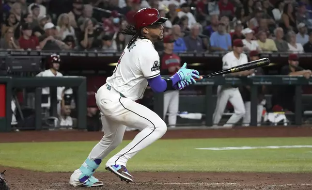 Arizona Diamondbacks' Ketel Marte hits a single against the Houston Astros in the eighth inning during a baseball game, Wednesday, July 23, 2025, in Phoenix. (AP Photo/Rick Scuteri)