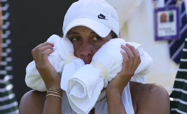Madison Keys of the U.S. uses an ice towel to cool during her first round women's single match against Elena-Gabriela Ruse at the Wimbledon Tennis Championships in London, Monday, June 30, 2025. (AP Photo/Kirsty Wigglesworth)