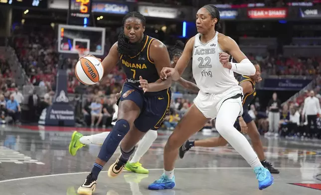 Indiana Fever's Aliyah Boston (7) goes to the basket against Las Vegas Aces' A'ja Wilson (22) during the first half of a WNBA basketball game, Thursday, July 3, 2025, in Indianapolis. (AP Photo/Michael Conroy)