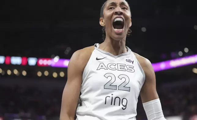 Las Vegas Aces' A'ja Wilson reacts after hitting a basket and being fouled during the second half of a WNBA basketball game against the Indiana Fever, Thursday, July 3, 2025, in Indianapolis. (AP Photo/Michael Conroy)