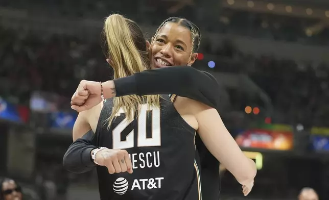 New York Liberty's Sabrina Ionescu (20) hugs New York Liberty's Natasha Cloud during the 3-point contest at the WNBA All-Star basketball weekend, Friday, July 18, 2025, in Indianapolis. (AP Photo/Michael Conroy)