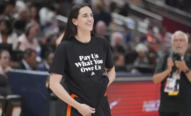Indiana Fever's Caitlin Clark watches before the WNBA All-Star basketball game, Saturday, July 19, 2025, in Indianapolis. (AP Photo/Michael Conroy)