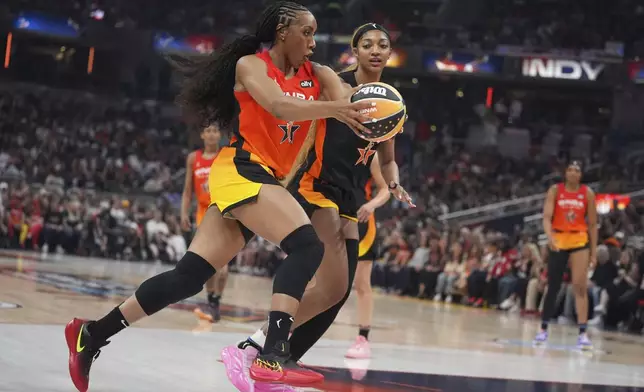 Golden State Valkyries' Kayla Thornton, left, goes to the basket against Chicago Sky's Angel Reese during the first half of a WNBA All-Star basketball game, Saturday, July 19, 2025, in Indianapolis. (AP Photo/Michael Conroy)