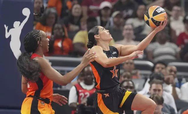 Los Angeles Sparks's Kelsey Plum, right, puts up a shot against Golden State Valkyries' Kayla Thornton during the first half of a WNBA All-Star basketball game, Saturday, July 19, 2025, in Indianapolis. (AP Photo/Michael Conroy)