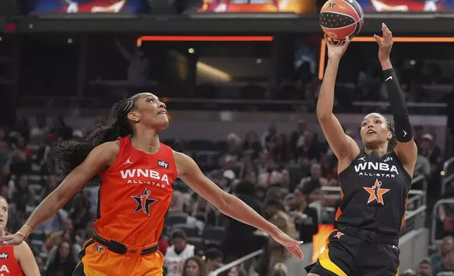 Minnesota Lynx's Napheesa Collier, right, shoots against Las Vegas Aces' A'ja Wilson during the second half of a WNBA All-Star basketball game, Saturday, July 19, 2025, in Indianapolis. (AP Photo/Michael Conroy)