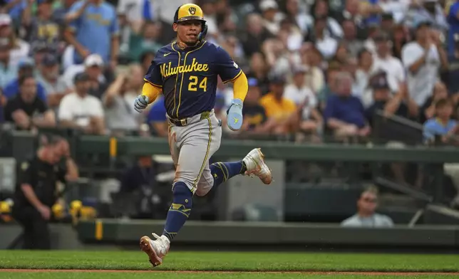 Milwaukee Brewers' William Contreras scores on a throwing error from Seattle Mariners relief pitcher Brandyn Garcia during the eighth inning of a baseball game Monday, July 21, 2025, in Seattle. (AP Photo/Lindsey Wasson)