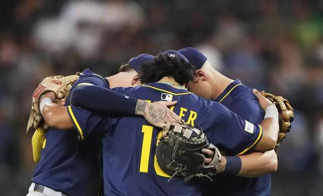 The Milwaukee Brewers infield, including third baseman Anthony Seigler (18) celebrate a win over the Seattle Mariners in a baseball game Monday, July 21, 2025, in Seattle. (AP Photo/Lindsey Wasson)