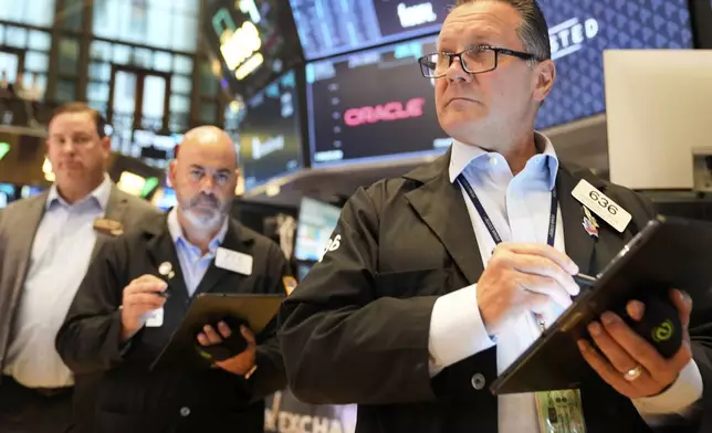 Ed Curran works on the floor at the New York Stock Exchange in New York, Wednesday, July 16, 2025. (AP Photo/Seth Wenig)