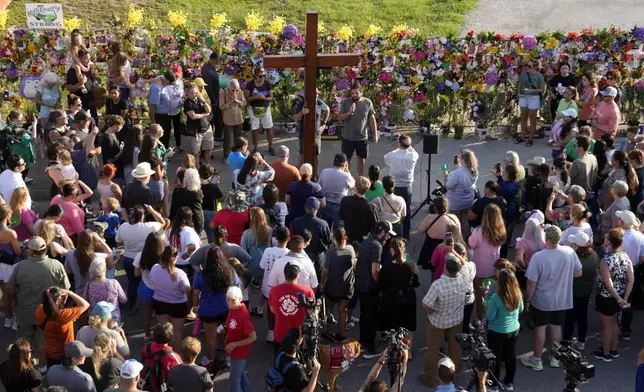 People gather for a vigil for flood victims on Friday, July 11, 2025, in Kerrville, Texas. (AP Photo/Gerald Herbert)