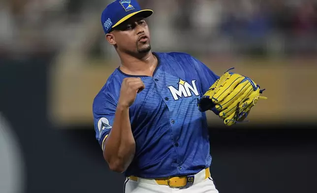 Minnesota Twins relief pitcher Jhoan Duran celebrates after forcing the final out of a baseball game against the Pittsburgh Pirates, Friday, July 11, 2025, in Minneapolis. (AP Photo/Abbie Parr)