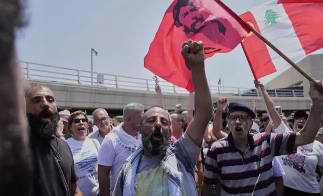 Supporters of Lebanese pro-Palestinian militant George Abdallah, who was serving a life sentence for complicity in the 1982 murders of an American and an Israeli diplomat in Paris, shout slogans as they wait for his arrival at Rafic Hariri International Airport in Beirut, Lebanon, Friday, July 25, 2025. (AP Photo/Hussein Malla)