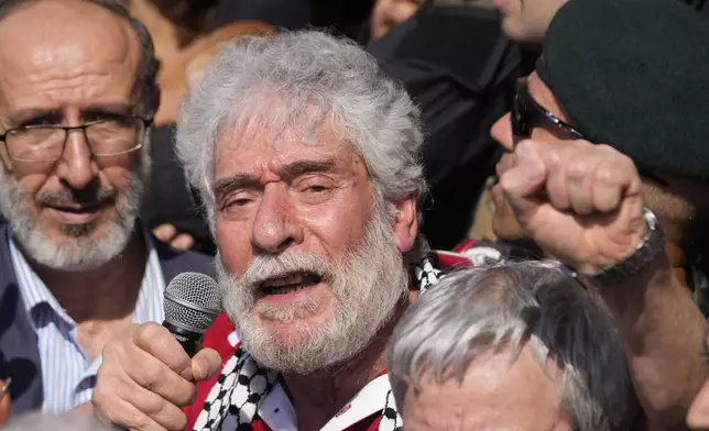 Lebanese pro-Palestinian militant Georges Abdallah, who was serving a life sentence for complicity in the 1982 murders of an American and an Israeli diplomat in Paris, speaks to supporters upon his arrival at Beirut's Rafik Hariri International Airport in Beirut, Lebanon, Friday, July 25, 2025. (AP Photo/Hussein Malla)
