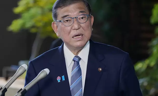 Japanese Prime Minister Shigeru Ishiba speaks to the media after President Donald Trump announced a trade framework with Japan, at the prime minister's office in Tokyo, Japan, Wednesday, July 23, 2025. (Kyodo News via AP)