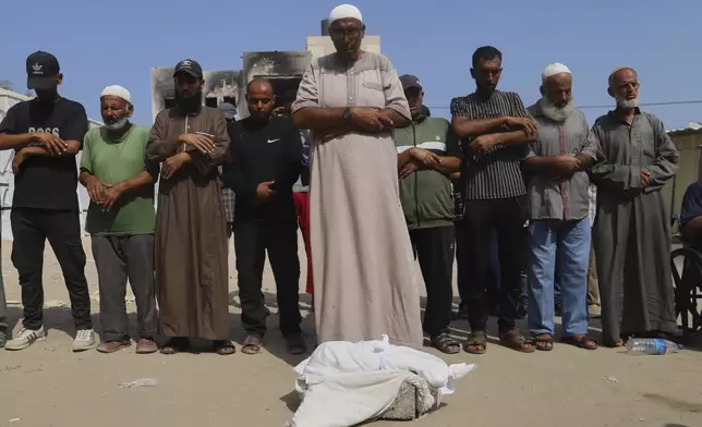 Palestinians pray over the body of 5-month-old baby, Zainab Abu Halib, who died from malnutrition-related causes, according to the family and the hospital, during her funeral outside the Nasser Hospital, in Khan Younis, Gaza Strip, Saturday, July 26, 2025. (AP Photo/Mariam Dagga)