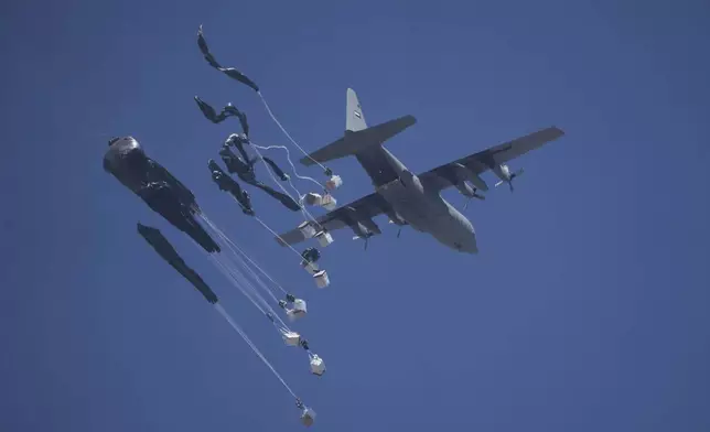 Humanitarian aid is airdropped to Palestinians over Gaza City, Gaza Strip, Sunday, July 27, 2025. (AP Photo/Jehad Alshrafi)