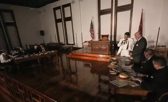 Larry Jones, who portrays William Jennings Bryan, in white suit, rehearses with other actors in the play "Destiny in Dayton", July 8, 2025, in Dayton, Tenn. (AP Photo/Mike Stewart)