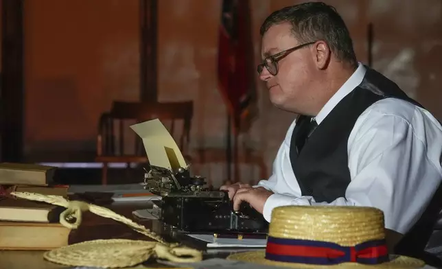 Anthony Smith who plays the roles of Walter White and Sue Hicks in the play "Destiny in Dayton" sits with a typewriter during a rehearsal, July 8, 2025, in Dayton, Tenn. (AP Photo/Mike Stewart)