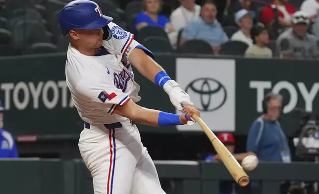 Texas Rangers' Josh Jung hits a home run during the third inning of a baseball game against the Athletics, Monday, July 21, 2025, in Arlington, Texas. (AP Photo/LM Otero)