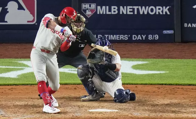 Philadelphia Phillies' Kyle Schwarber hits a two-run home run during the eighth inning of a baseball game against the New York Yankees Friday, July 25, 2025, in New York. (AP Photo/Frank Franklin II)