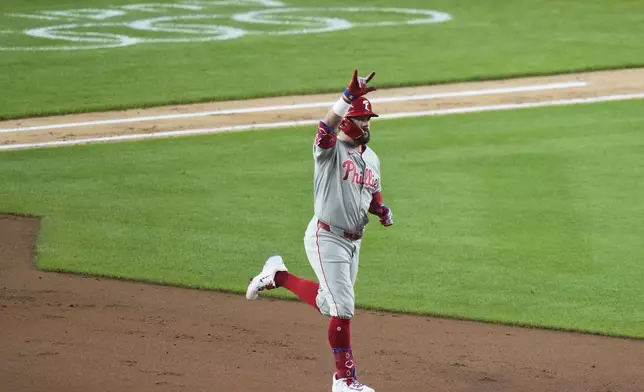 Philadelphia Phillies' Kyle Schwarber gestures as he runs the bases after hitting a two-run home run during the fifth inning of a baseball game against the New York Yankees Friday, July 25, 2025, in New York. (AP Photo/Frank Franklin II)