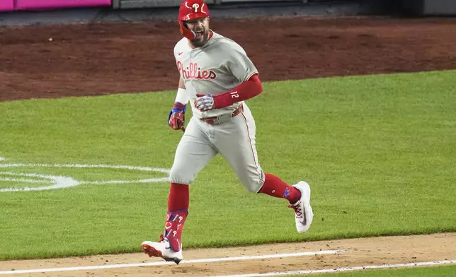 Philadelphia Phillies' Kyle Schwarber celebrates as he runs for a single during the seventh inning of a baseball game against the New York Yankees Friday, July 25, 2025, in New York. (AP Photo/Frank Franklin II)