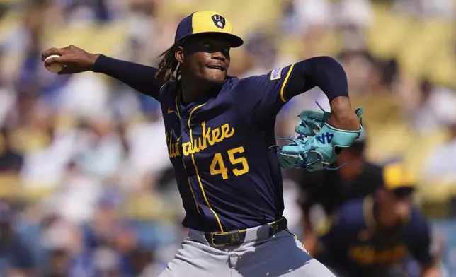 Milwaukee Brewers relief pitcher Abner Uribe throws to the plate during the ninth inning of a baseball game against the Los Angeles Dodgers, Sunday, July 20, 2025, in Los Angeles. (AP Photo/Mark J. Terrill)