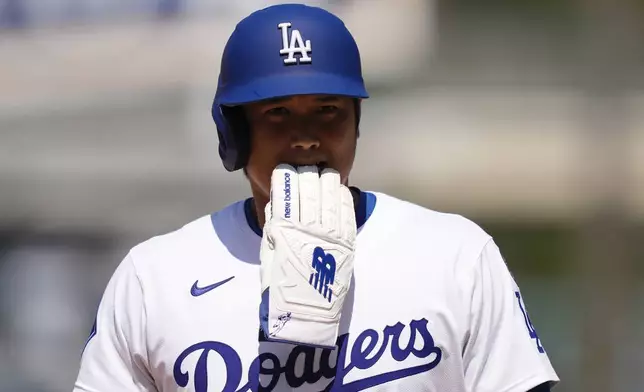 Los Angeles Dodgers' Shohei Ohtani walks off the field after eighth inning of a baseball game against the Milwaukee Brewers, Sunday, July 20, 2025, in Los Angeles. (AP Photo/Mark J. Terrill)