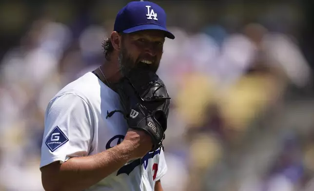 Los Angeles Dodgers starting pitcher Clayton Kershaw bites his glove after being taken out of the game I'm the fifth during inning of a baseball game against the Milwaukee Brewers, Sunday, July 20, 2025, in Los Angeles. (AP Photo/Mark J. Terrill)
