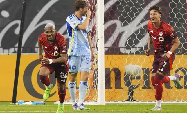 Toronto FC midfielder Deybi Flores (20) celebrates after scoring as Atlanta United's Aleksey Miranchuk (59) and Toronto FC's Theo Corbeanu (7) look on during second-half MLS soccer match action in Toronto, Saturday, July 12, 2025. (Chris Young/The Canadian Press via AP)